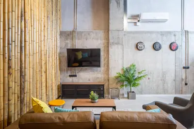 a living room with a couch and a tv at ART LOFTS Valencia by Benisur in Valencia