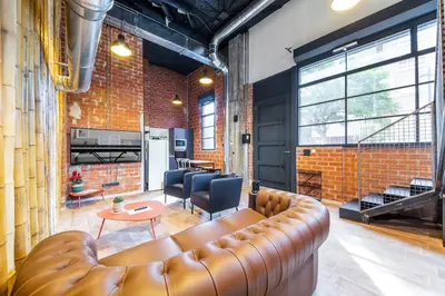a living room with a leather couch and a table at ART LOFTS Valencia by Benisur in Valencia