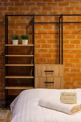 a bed with a sign on it next to a brick wall at ART LOFTS Valencia by Benisur in Valencia