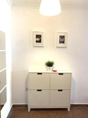 a white dresser with a plant on top of it at UIM Mediterraneo Diagonal 17 Wifi in Puerto de Sagunto