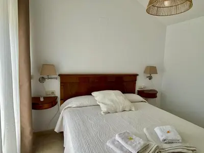 a bedroom with a bed with two towels on it at Ideal house at the Beach in Sagunto(Valencia) in Sagunto