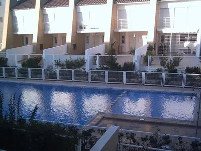 a large swimming pool in front of some buildings at Ideal house at the Beach in Sagunto(Valencia) in Sagunto