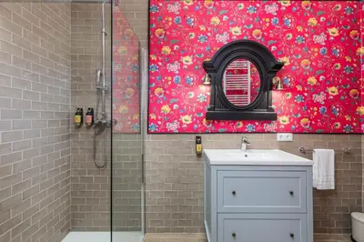 a bathroom with a shower with a sink and a mirror at Maison San Alfredo B&B in El Puig