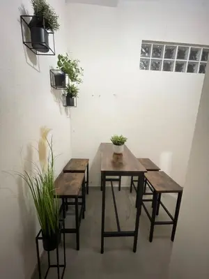 a table and chairs in a room with potted plants at UIM Mediterraneo PB Aragon A Wifi in Puerto de Sagunto