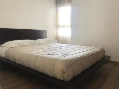 a bedroom with a bed with white sheets and a window at Enjoy Valencia in Valencia