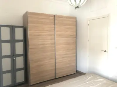 a large wooden cabinet in a room with a bed at Enjoy Valencia in Valencia