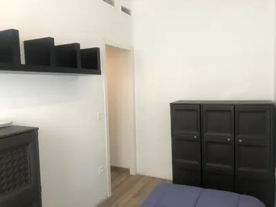 a bedroom with a black cabinet and a white wall at Enjoy Valencia in Valencia