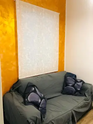 a green couch with two pillows in a room at Enjoy Valencia in Valencia