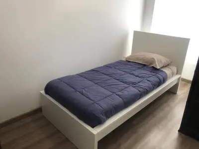 a bed with a blue blanket on it in a room at Enjoy Valencia in Valencia