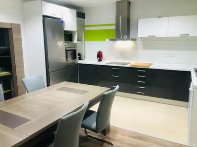 a large kitchen with a wooden table and chairs at Enjoy Valencia in Valencia