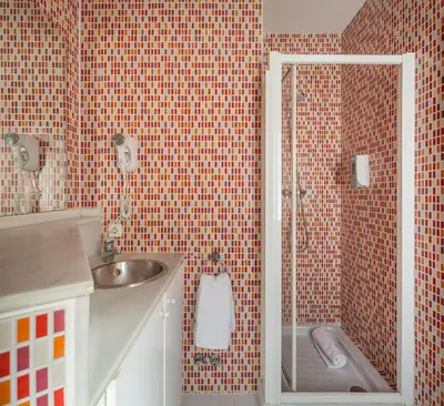 a small bathroom with a shower and a sink at Stancia Carmen in Valencia