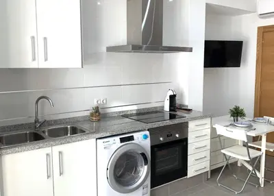 a kitchen with a washing machine and a sink at UIM Mediterraneo Casita Palancia Wifi in Puerto de Sagunto