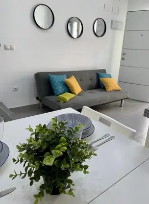 a living room with a table and a couch at UIM Mediterraneo Casita Palancia Wifi in Puerto de Sagunto