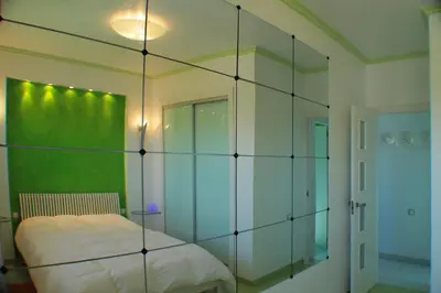 a bedroom with a large glass wall at Mareny Blau, primera linea de playa in Mareny Blau