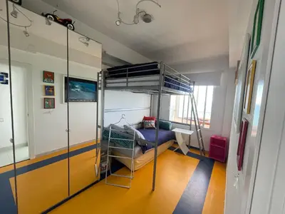 a room with a bunk bed and a desk at Mareny Blau, primera linea de playa in Mareny Blau