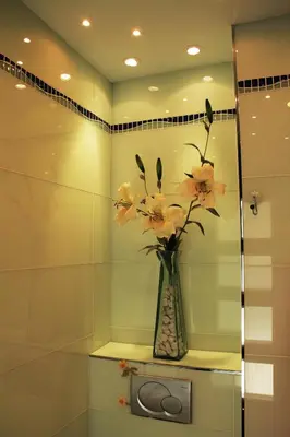 a vase of flowers sitting on a shelf in a bathroom at Mareny Blau, primera linea de playa in Mareny Blau