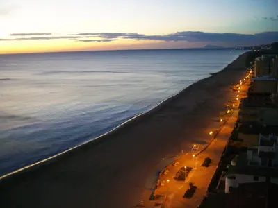 a view of a beach at night with lights at Mareny Blau, primera linea de playa in Mareny Blau