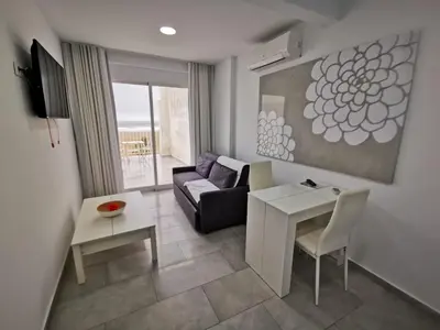 a living room with a couch and a table at Sol Playa Suites in Valencia