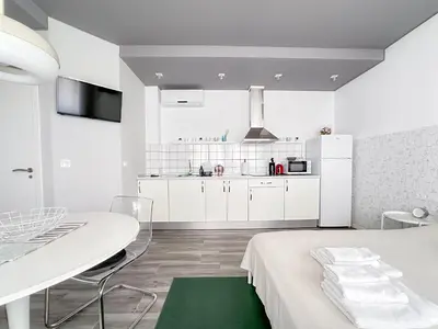 a white kitchen with a white table and a white dining room at Budget Inn in Valencia