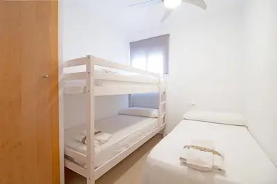 a bunk bed room with two bunk beds in a room at Global Vacacional, Apartamento en la playa de Canet d'en Berenguer in Canet de Berenguer