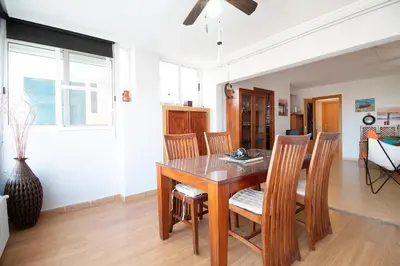 a living room with a couch and a table and chairs at Global Vacacional, Apartamento con buenas vistas en Canet playa in Canet de Berenguer