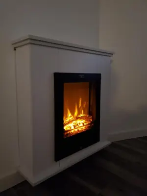 a fireplace in the corner of a room at Intimo y Acogedor 