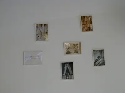 a wall with pictures on a white wall at Intimo y Acogedor 