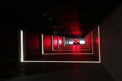 a dark tunnel with a red car in the background at Hotel Loob Valencia in Mislata