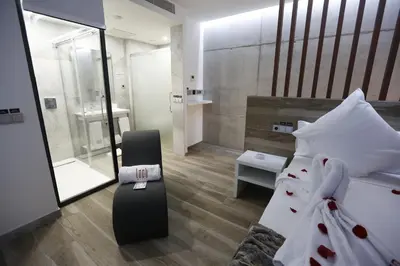 a bedroom with a bed and a chair in it at Hotel Loob Valencia in Mislata