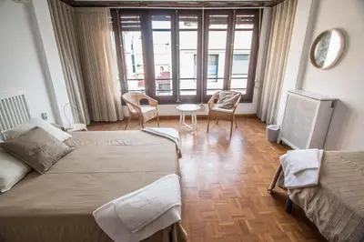 a hotel room with two beds and a table and chairs at Rotaret in Valencia