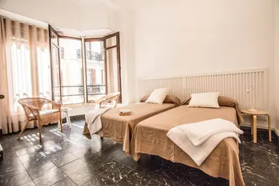 a bedroom with two beds and a large window at Rotaret in Valencia
