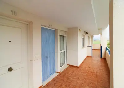 an empty hallway of a building with a door at Global Vacacional, Apartamento con piscina en playa Corinto in Sagunto