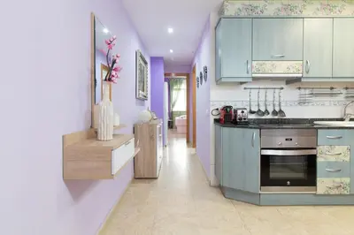 a kitchen with purple cabinets and a stove top oven at Global Vacacional, Estudio para parejas en la playa del Puerto de Sagunto in Puerto de Sagunto