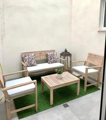 a patio with three chairs and a table and a bench at UIM Mediterraneo PB Aragon B Wifi in Puerto de Sagunto