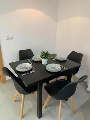 a black table with chairs and plates on it at UIM Mediterraneo PB Aragon B Wifi in Puerto de Sagunto