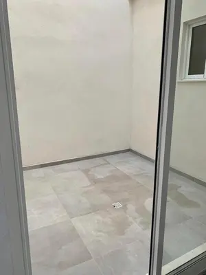 a glass door in a room with a tile floor at UIM Mediterraneo PB Aragon B Wifi in Puerto de Sagunto