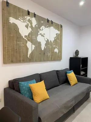 a living room with a couch with a map on the wall at UIM Mediterraneo PB Aragon B Wifi in Puerto de Sagunto