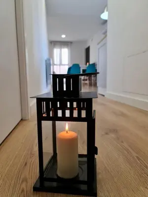 a candle sitting on a table in a room at Alojamientos Segóbriga Rural ( Mandil) in Segorbe