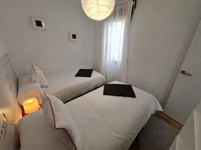two beds in a small room with a window at Alojamientos Segóbriga Rural ( Mandil) in Segorbe