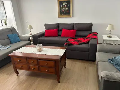 a living room with two couches and a coffee table at 150m2 Con vistas al Mar y al Castillo de Cullera in Cullera