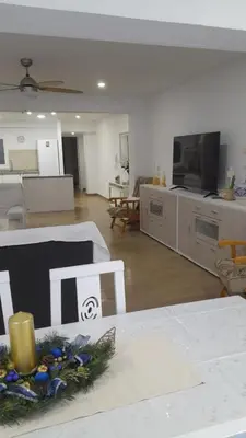a living room with a couch and a tv at 150m2 Con vistas al Mar y al Castillo de Cullera in Cullera