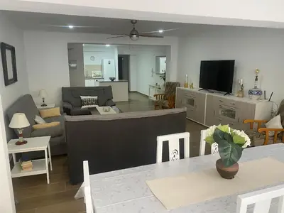 a living room with a couch and a tv at 150m2 Con vistas al Mar y al Castillo de Cullera in Cullera