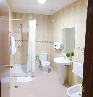 a bathroom with a toilet and a sink and a shower at Hotel M5 Valencia Aeropuerto in Manises