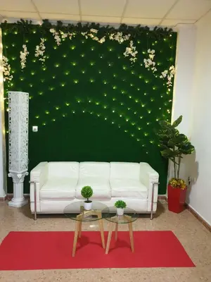 a living room with a white couch and a green wall at Hotel M5 Valencia Aeropuerto in Manises