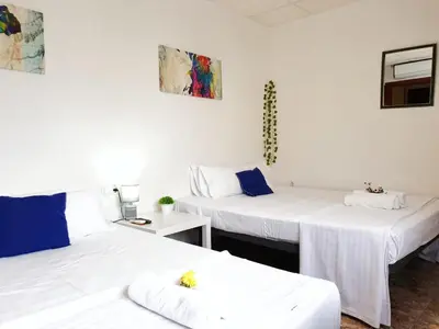 two beds in a room with white sheets at Hotel M5 Valencia Aeropuerto in Manises