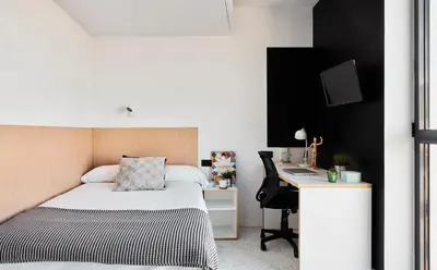 a bedroom with a bed and a desk with a computer at Resa Patacona in Valencia
