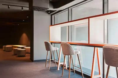 a group of chairs sitting around a bar in a room at Resa Patacona in Valencia