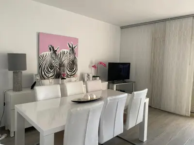 a white dining room with a white table and white chairs at 1a línea con PISCINA Nuevo in Cullera