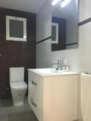a bathroom with a white sink and a toilet at 1a línea con PISCINA Nuevo in Cullera