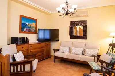 a living room with a couch and a flat screen tv at FLORIT FLATS - The Orange Lemon Tree House in La Eliana